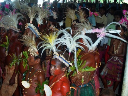 Jungle Eucharist Children in a primitive area of Papua New Guinea dress in their cultural attire at a First Communion celebration.